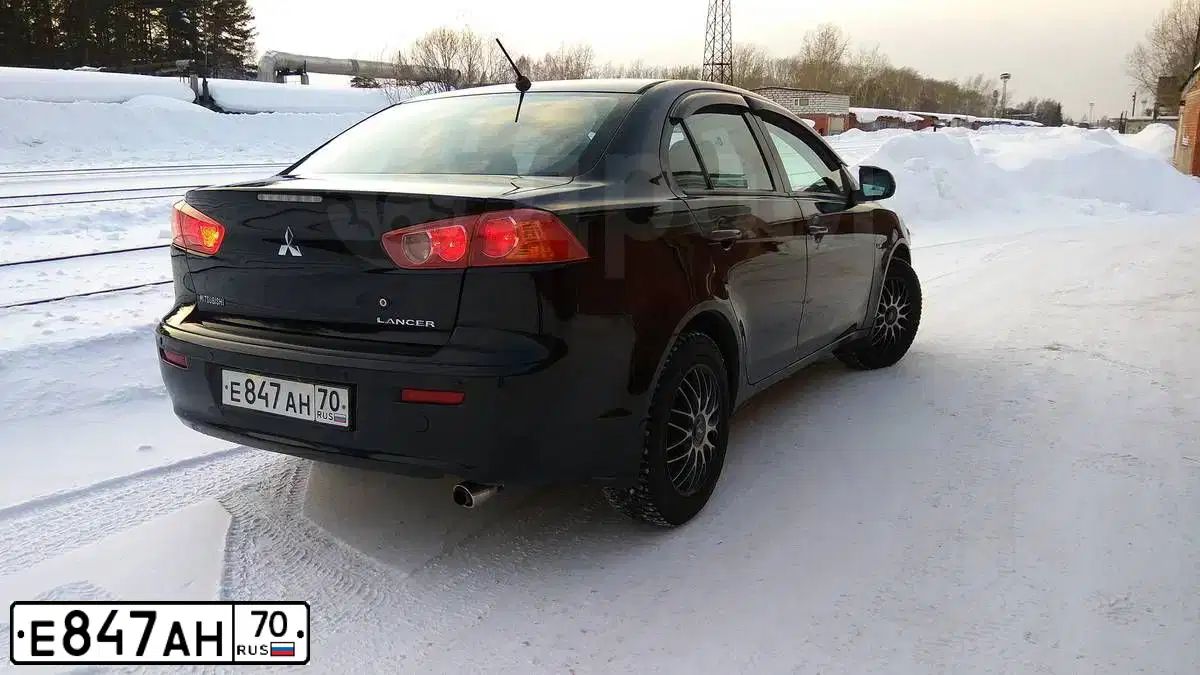 Фото автомобиля MITSUBISHI LANCER, 2007 — госномер Е847АН70. Цвет: ЧЕРНЫЙ