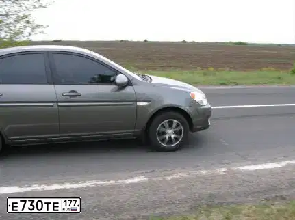 Фото автомобиля LADA 1118 KALINA, 2007 — госномер Е730ТЕ177. Цвет: СЕРО-СИНИЙ