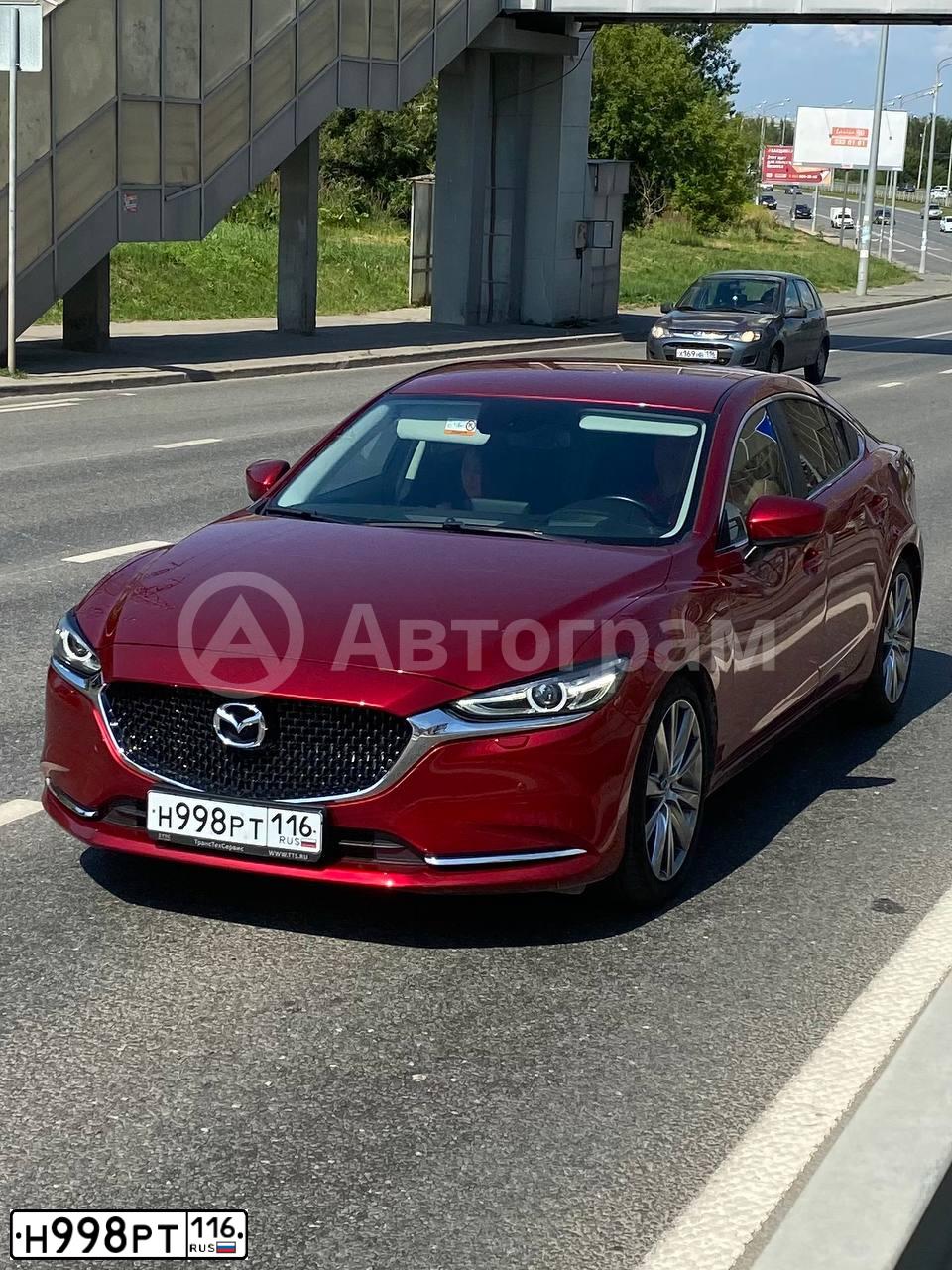 Фото автомобиля MAZDA A 3, 2010 — госномер В054ХА716. Цвет: Красный