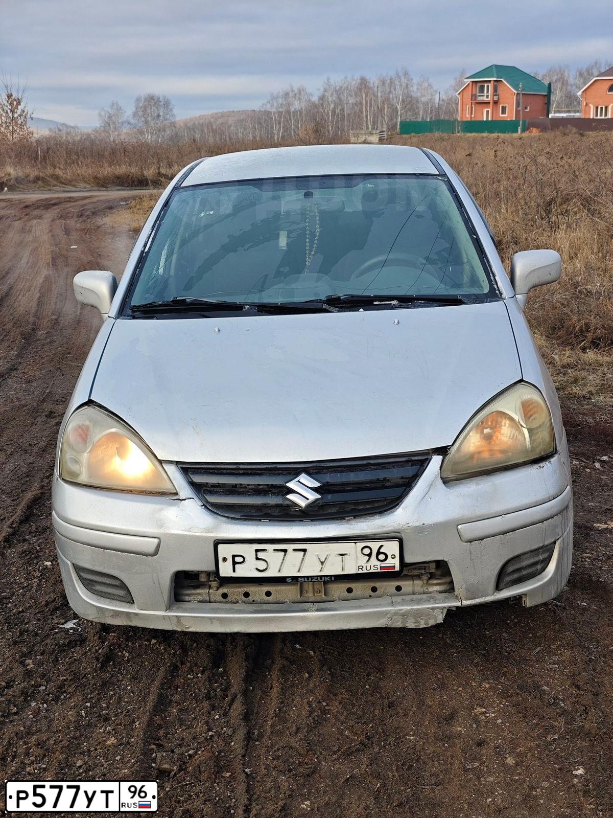 Фото автомобиля SUZUKI LIANA, 2004 — госномер Р577УТ96. Цвет: СЕРЫЙ