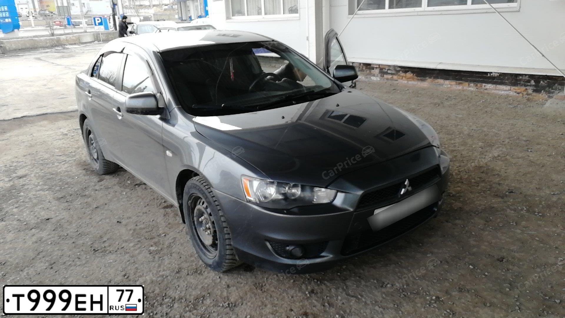 Фото автомобиля MITSUBISHI LANCER, 2010 — госномер Т999ЕН77. Цвет: Серый