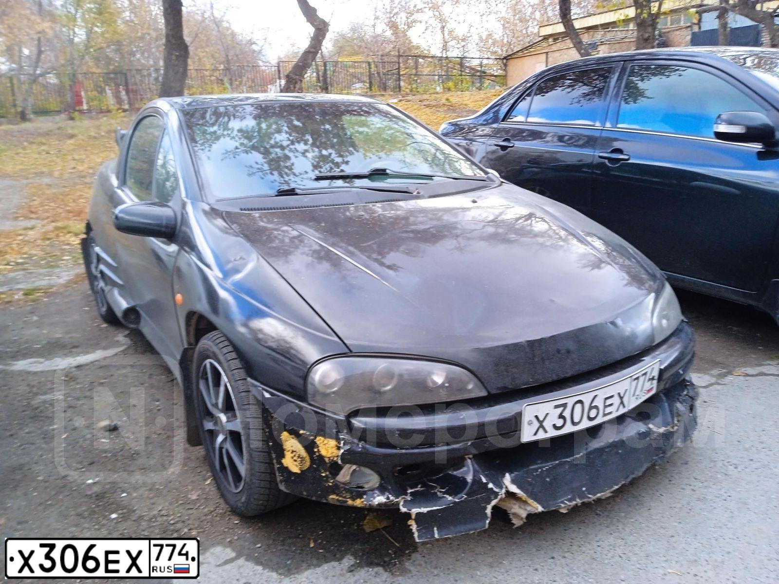 Фото автомобиля OPEL TIGRA, 1999 — госномер Х306ЕХ774. Цвет: ЧЕРНЫЙ