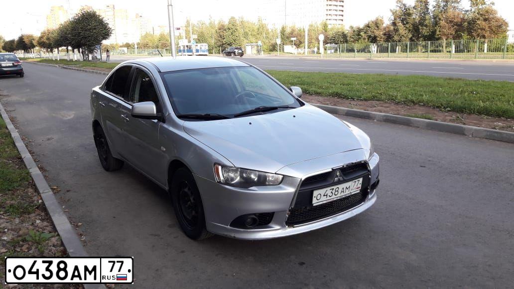 Фото автомобиля MITSUBISHI LANCER, 2012 — госномер О438АМ77. Цвет: Серый