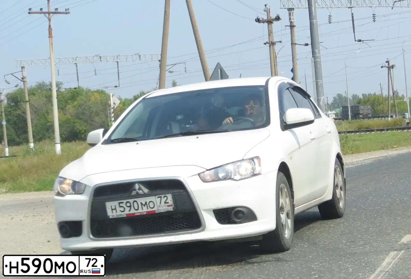 Фото автомобиля MITSUBISHI LANCER, 2011 — госномер Н590МО72. Цвет: Белый