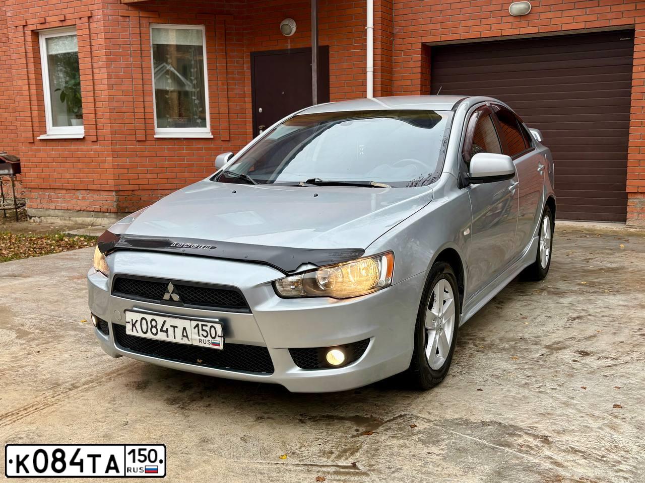 Фото автомобиля MITSUBISHI LANCER, 2008 — госномер К084ТА150. Цвет: СЕРЕБРИСТЫЙ