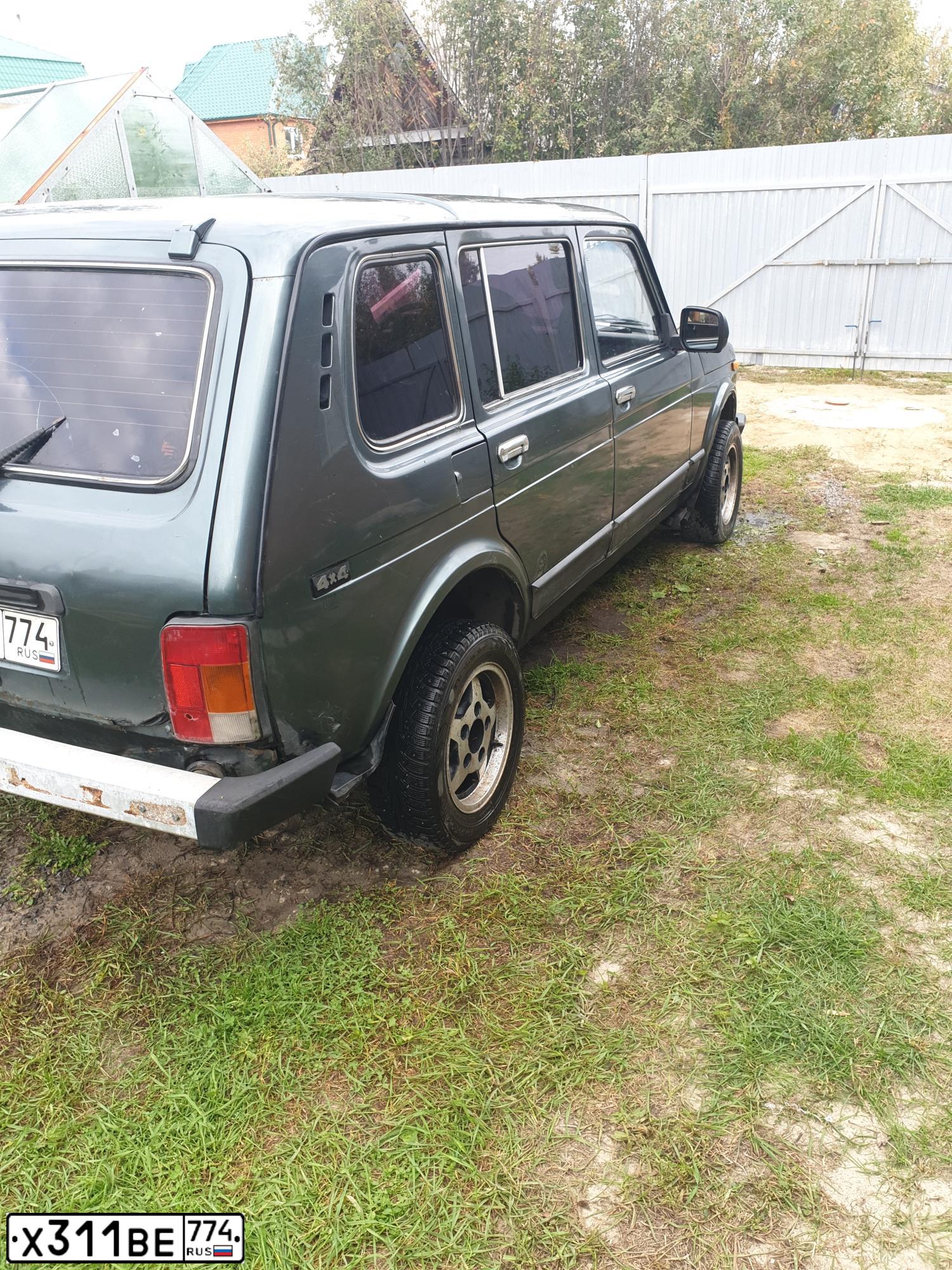 Фото автомобиля LADA 2131 NIVA, 2006 — госномер Х311ВЕ774. Цвет: СЕРО-СИНЕ-ЗЕЛЕНЫЙ