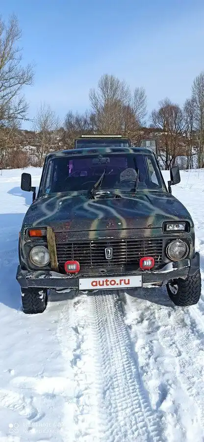 Фото автомобиля LADA 2121 NIVA, 1998 — госномер Е214ЕУ150. Цвет: ЗЕЛЕНЫЙ