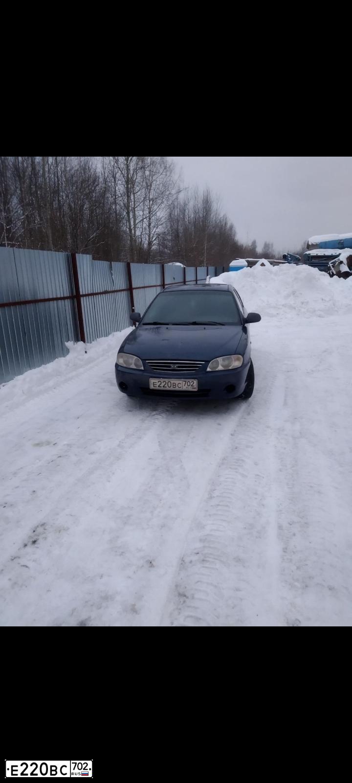 Фото автомобиля KIA SPECTRA, 2006 — госномер Е220ВС702. Цвет: ТЕМНО-СИНИЙ
