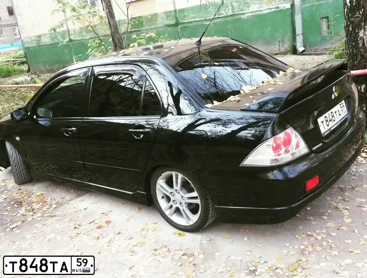 Фото автомобиля MITSUBISHI LANCER, 2007 — госномер К836РЕ21. Цвет: ЧЕРНЫЙ