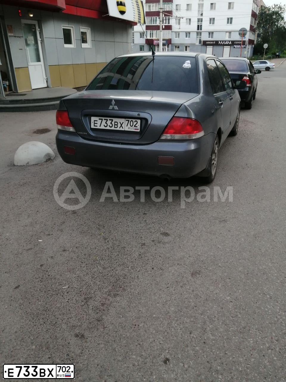 Фото автомобиля MITSUBISHI LANCER 1.6, 2005 — госномер Е733ВХ702. Цвет: СЕРЫЙ