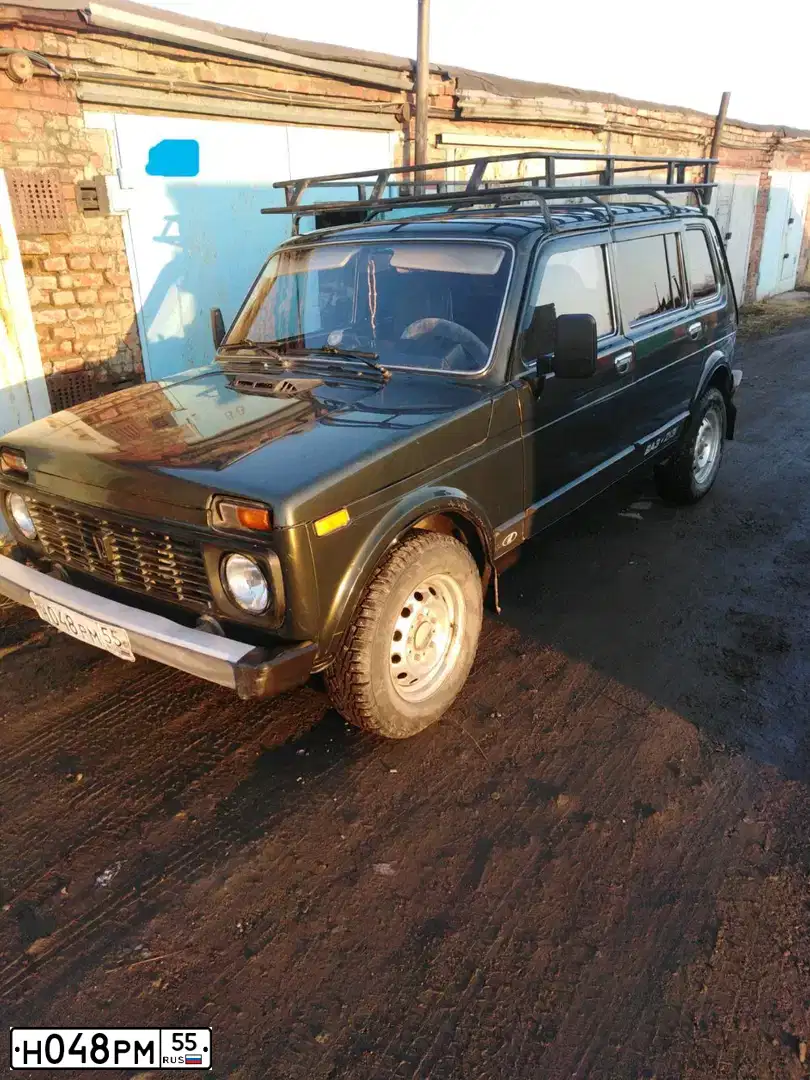 Фото автомобиля LADA 2131 NIVA, 2007 — госномер Н048РМ55. Цвет: Темно-зеленый