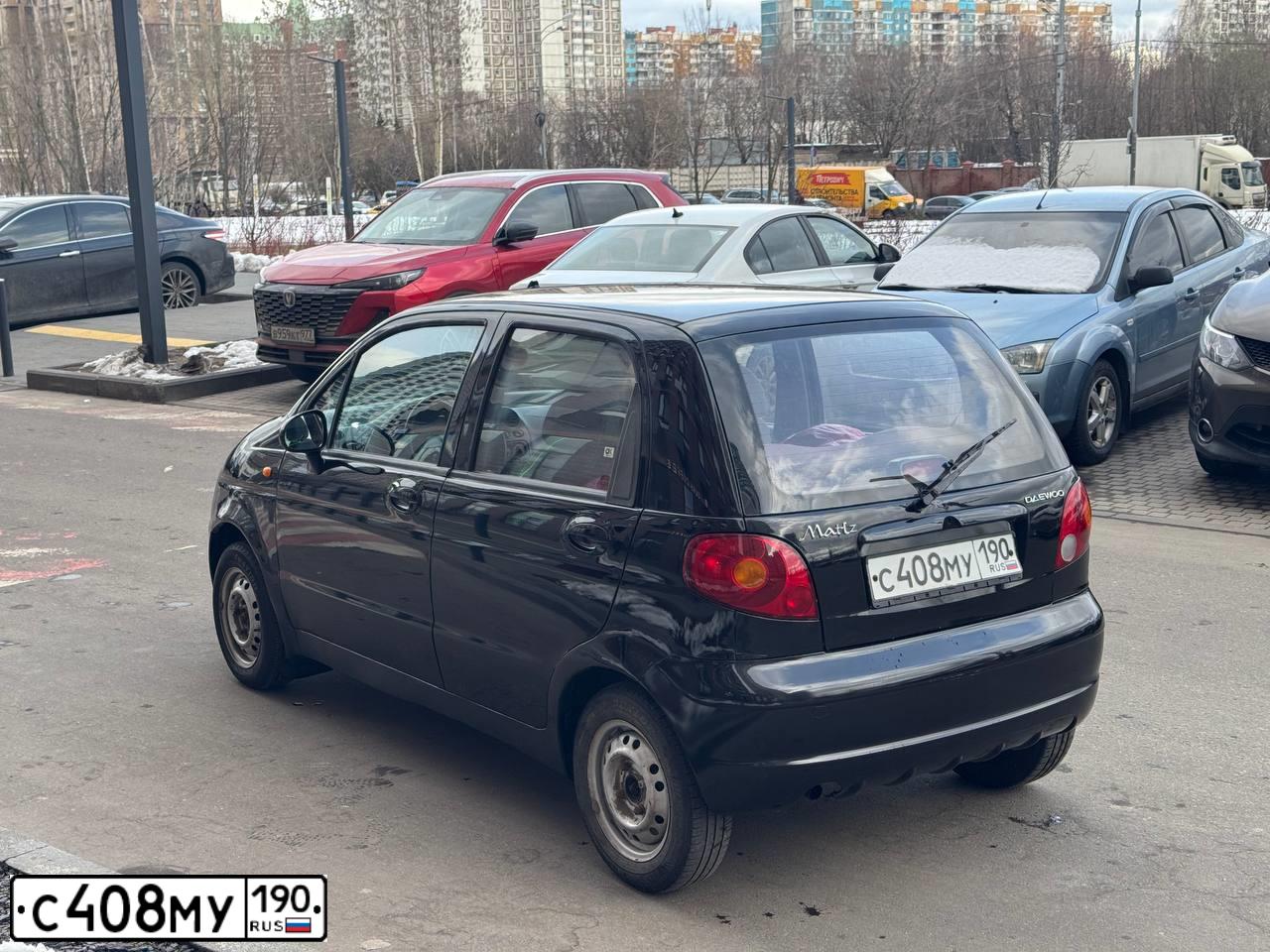 Фото автомобиля DAEWOO MATIZ, 2010 — госномер К772МЕ977. Цвет: ЧЕРНЫЙ БЛЕДНЫЙ