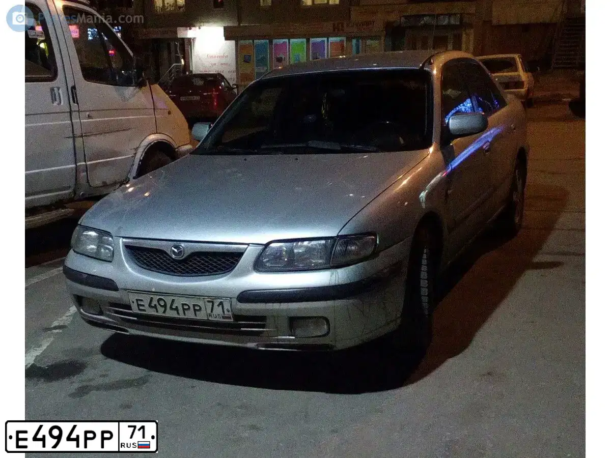 Фото автомобиля MAZDA 626, 1999 — госномер Е494РР71. Цвет: БЕЛЫЙ(СЕРЕБРИСТЫЙ