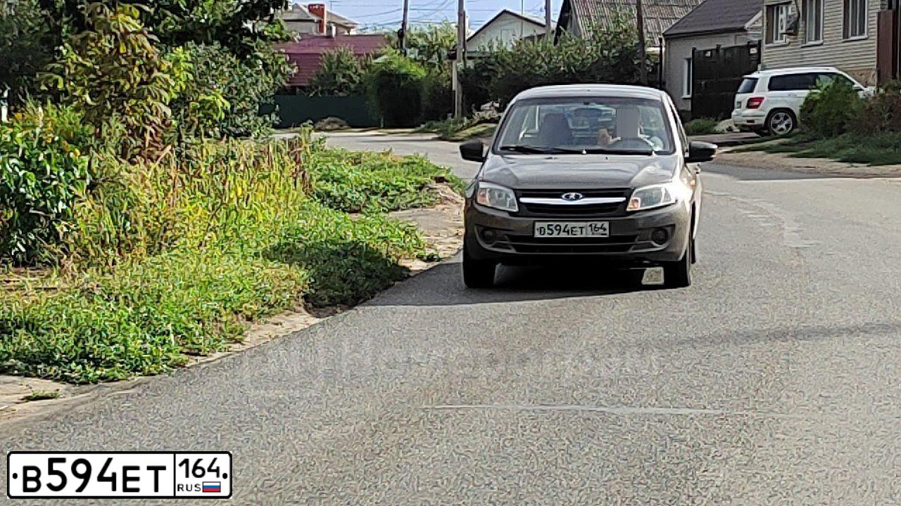 Фото автомобиля LADA 2190 GRANTA, 2017 — госномер В594ЕТ164. Цвет: ЗОЛОТИСТО-КОРИЧНЕВЫЙ