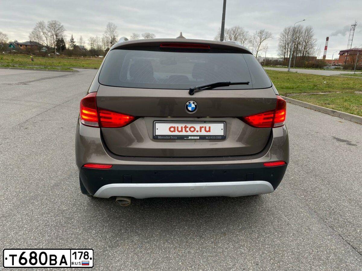 Фото автомобиля BMW X1, 2012 — госномер Е754АР147. Цвет: Коричневый