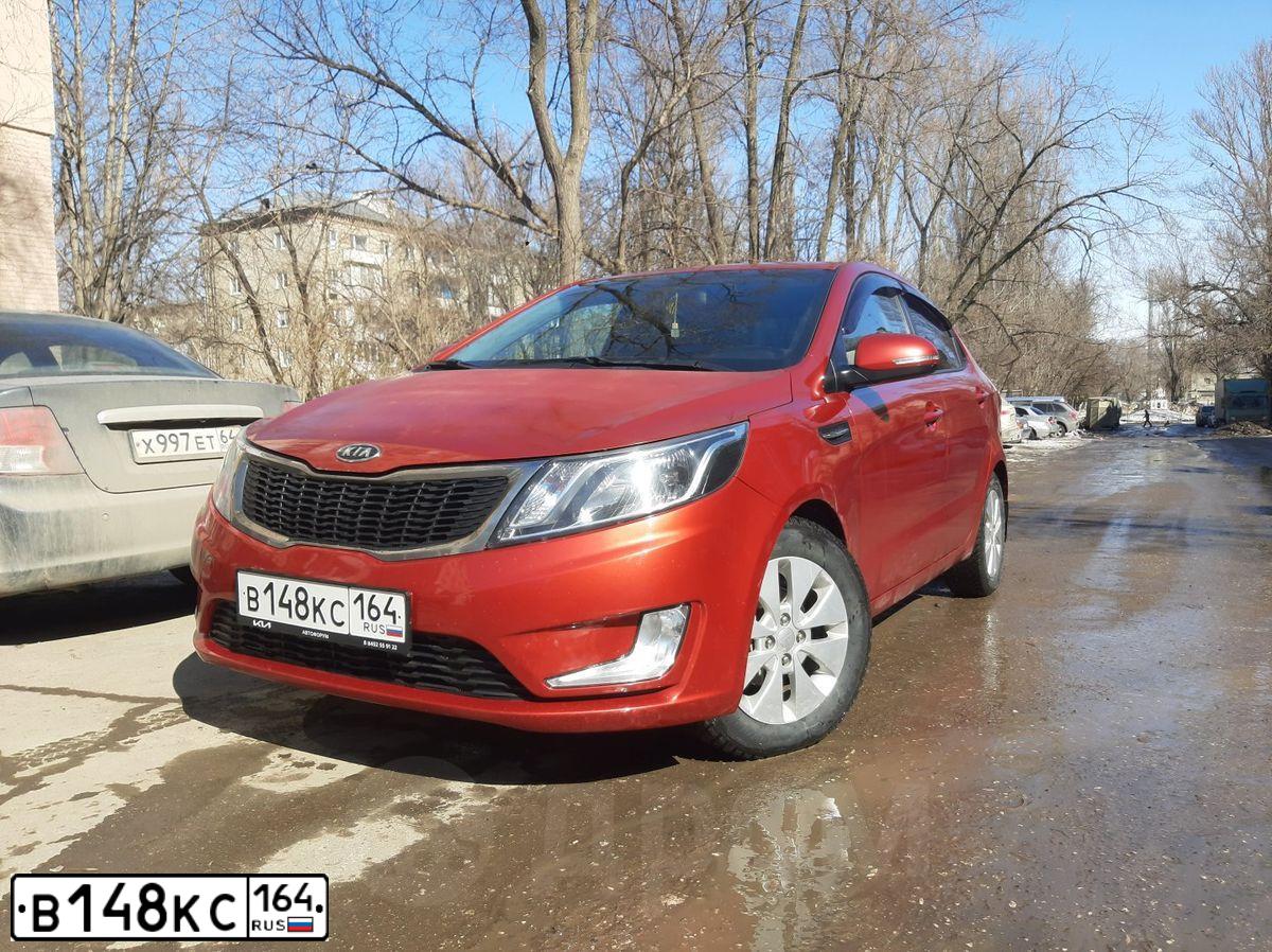 Фото автомобиля KIA RIO, 2012 — госномер В148КС164. Цвет: Красный