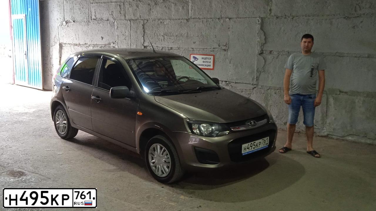 Фото автомобиля LADA KALINA, 2014 — госномер Н246ТР15. Цвет: золотисто коричневый