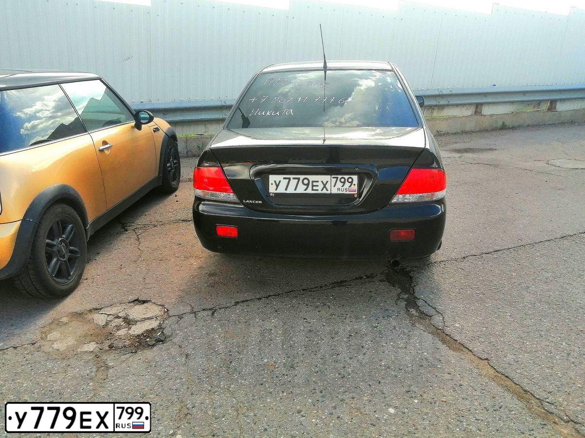 Фото автомобиля MITSUBISHI LANCER, 2007 — госномер С647ЕК774. Цвет: ЧЕРНЫЙ