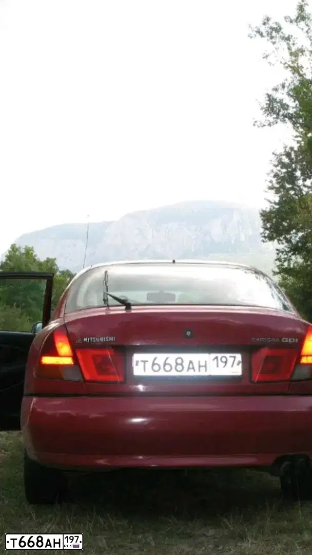 Фото автомобиля MITSUBISHI CARISMA, 1998 — госномер Н124НТ761