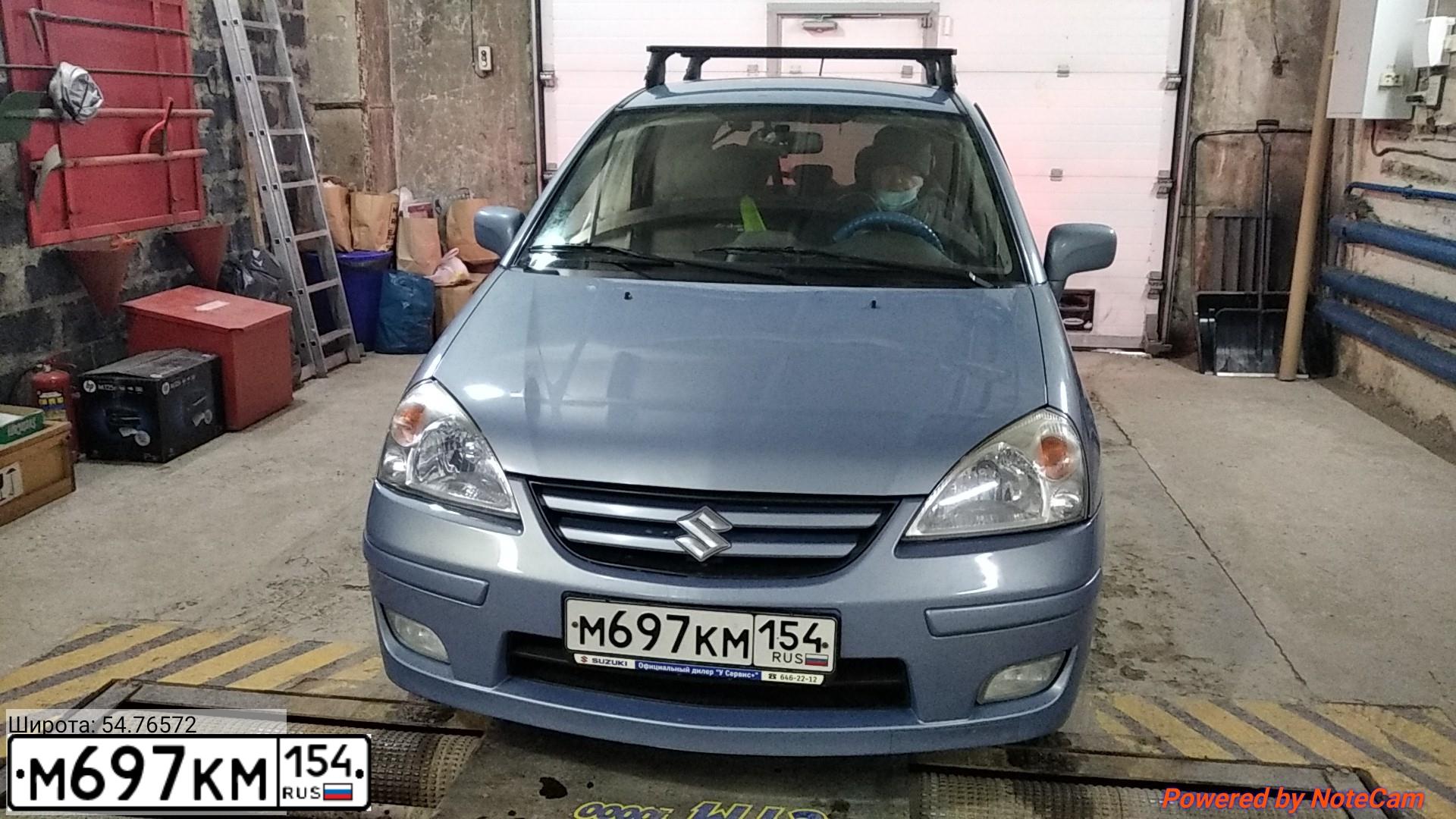 Фото автомобиля SUZUKI LIANA, 2007 — госномер М697КМ154. Цвет: СЕРО ГОЛУБОЙ