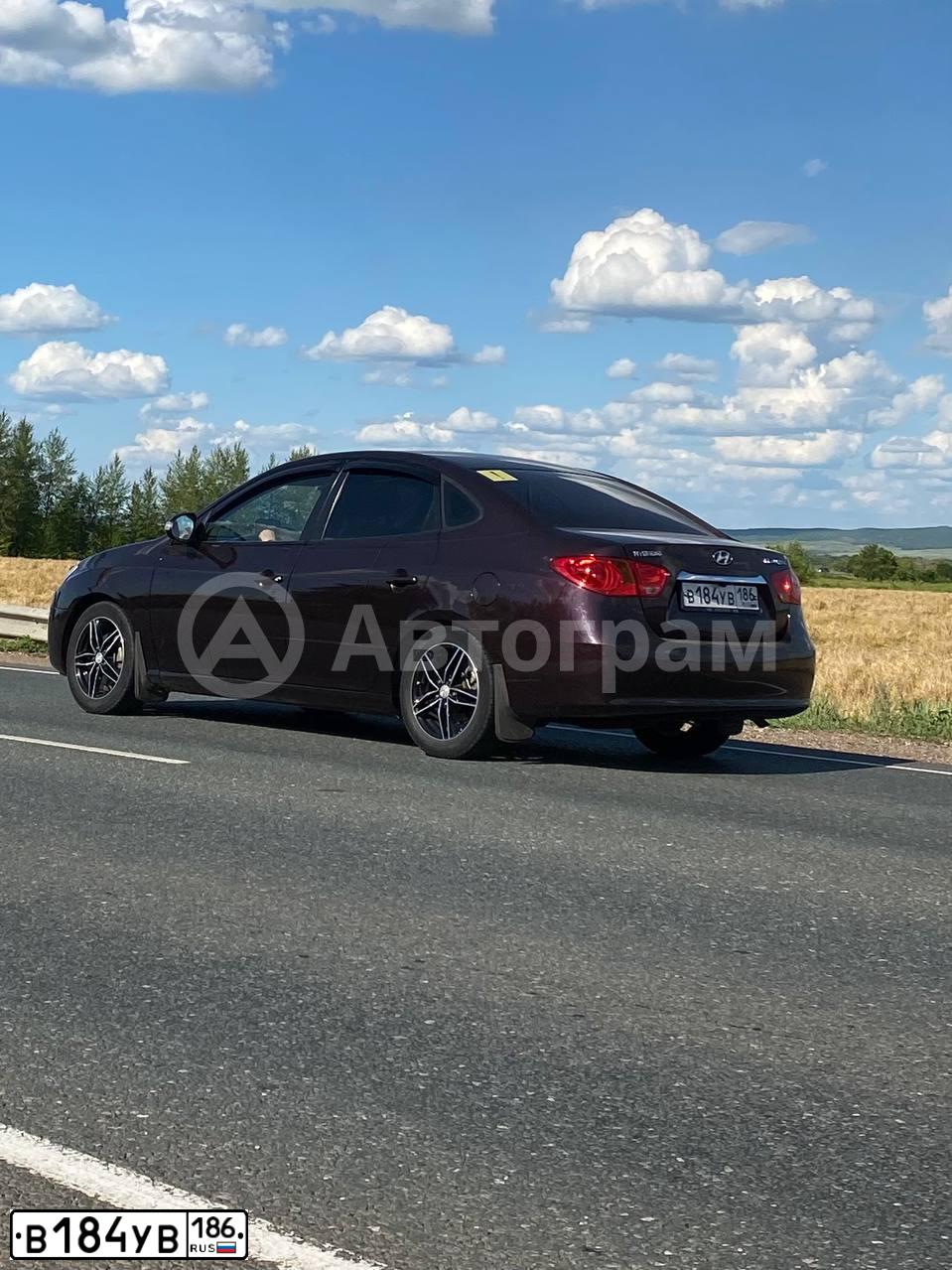 Фото автомобиля HYUNDAI ELANTRA, 2010 — госномер М247СР70. Цвет: ВИШНЕВЫЙ