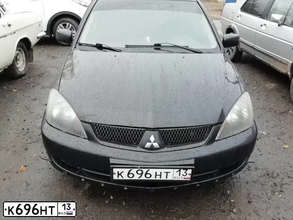 Фото автомобиля MITSUBISHI LANCER, 2005 — госномер М765ЕК13. Цвет: ЧЕРНЫЙ