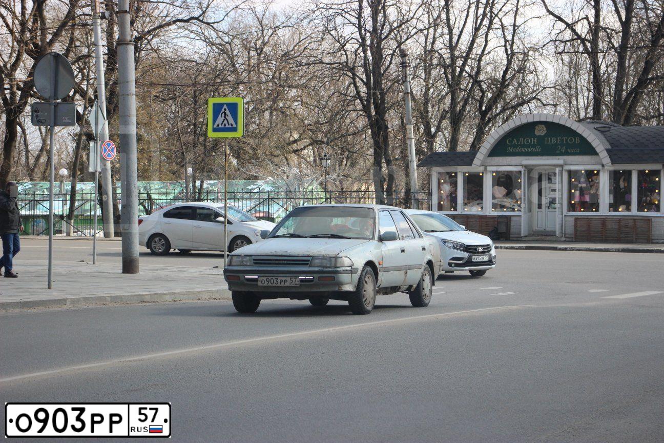 Фото автомобиля TOYOTA CARINA, 1988 — госномер О903РР57. Цвет: СИНИЙ