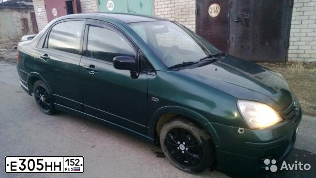 Фото автомобиля SUZUKI AERIO, 2002 — госномер Е305НН152. Цвет: ТЕМНО ЗЕЛЕНЫЙ