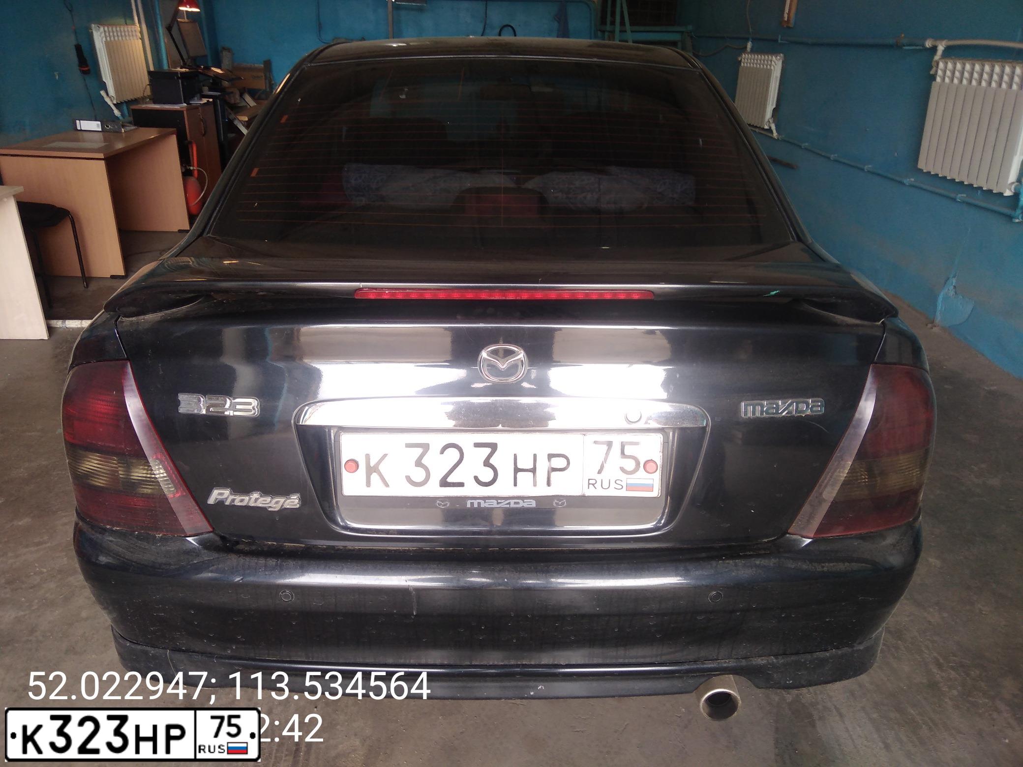 Фото автомобиля MAZDA 323, 2003 — госномер К323НР75. Цвет: ЧЕРНЫЙ