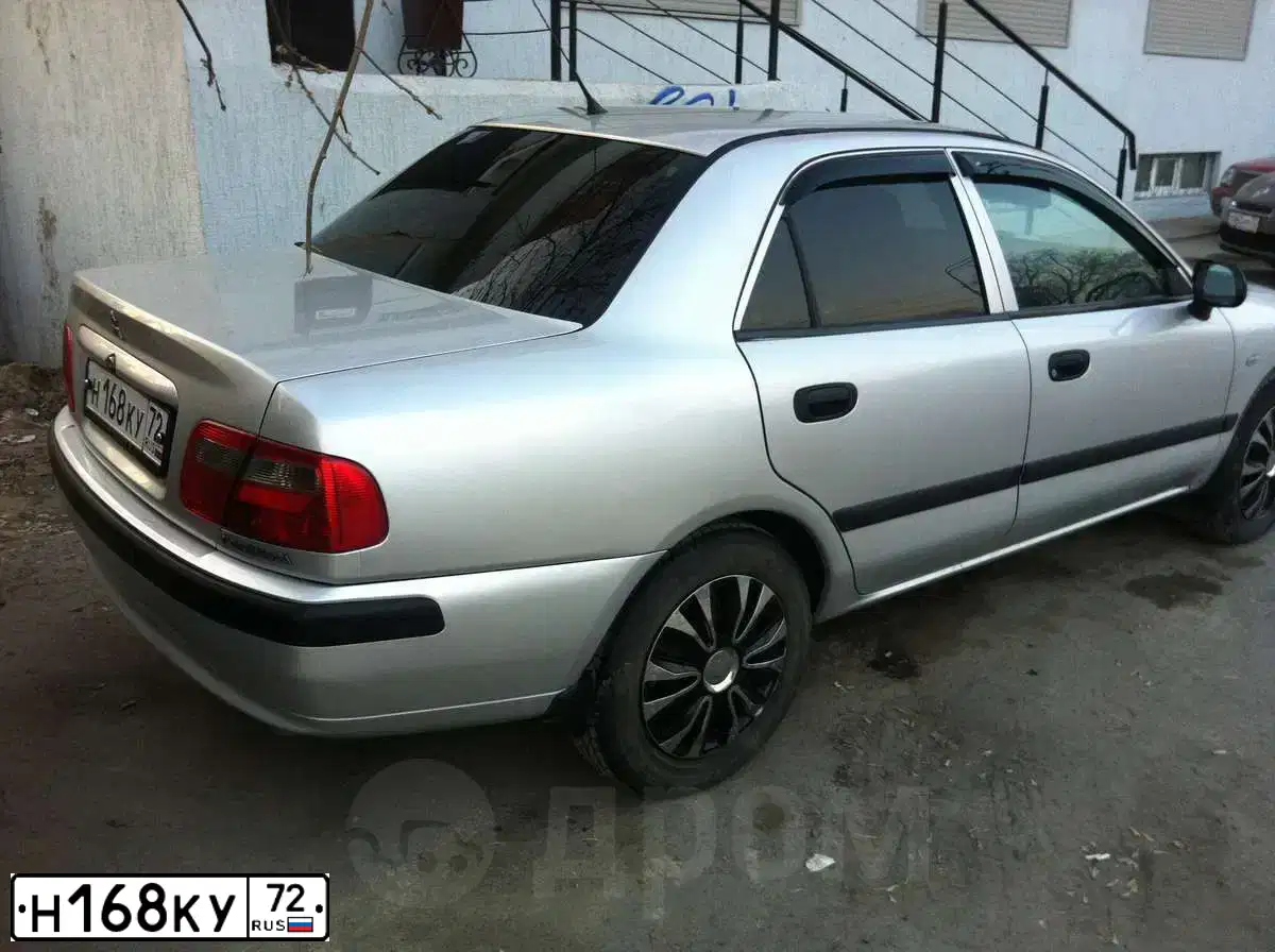 Фото автомобиля MITSUBISHI CARISMA, 2003 — госномер Р851СХ72. Цвет: Серебристый