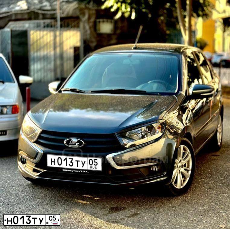 Фото автомобиля LADA 2190 GRANTA, 2015 — госномер Н013ТУ05. Цвет: ЧЕРНЫЙ