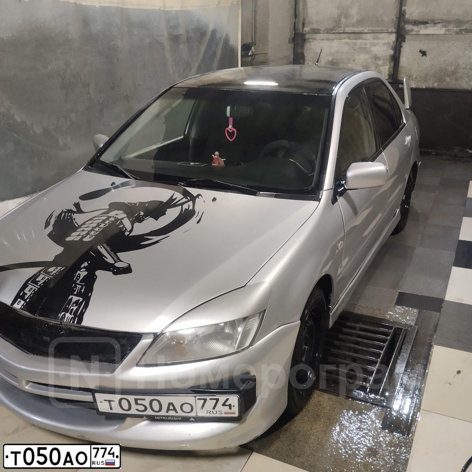 Фото автомобиля MITSUBISHI LANCER, 2006 — госномер Т050АО774. Цвет: СЕРЕБРИСТЫЙ