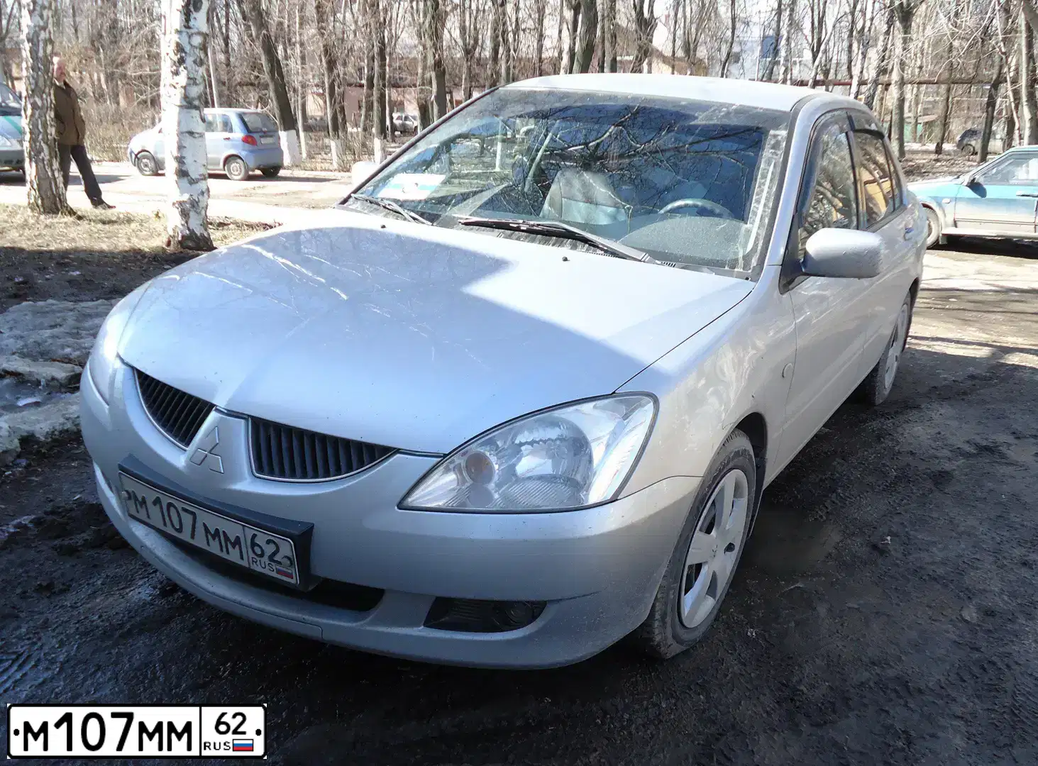 Фото автомобиля MITSUBISHI LANCER, 2003 — госномер М107ММ62. Цвет: СЕРЕБРИСТЫЙ