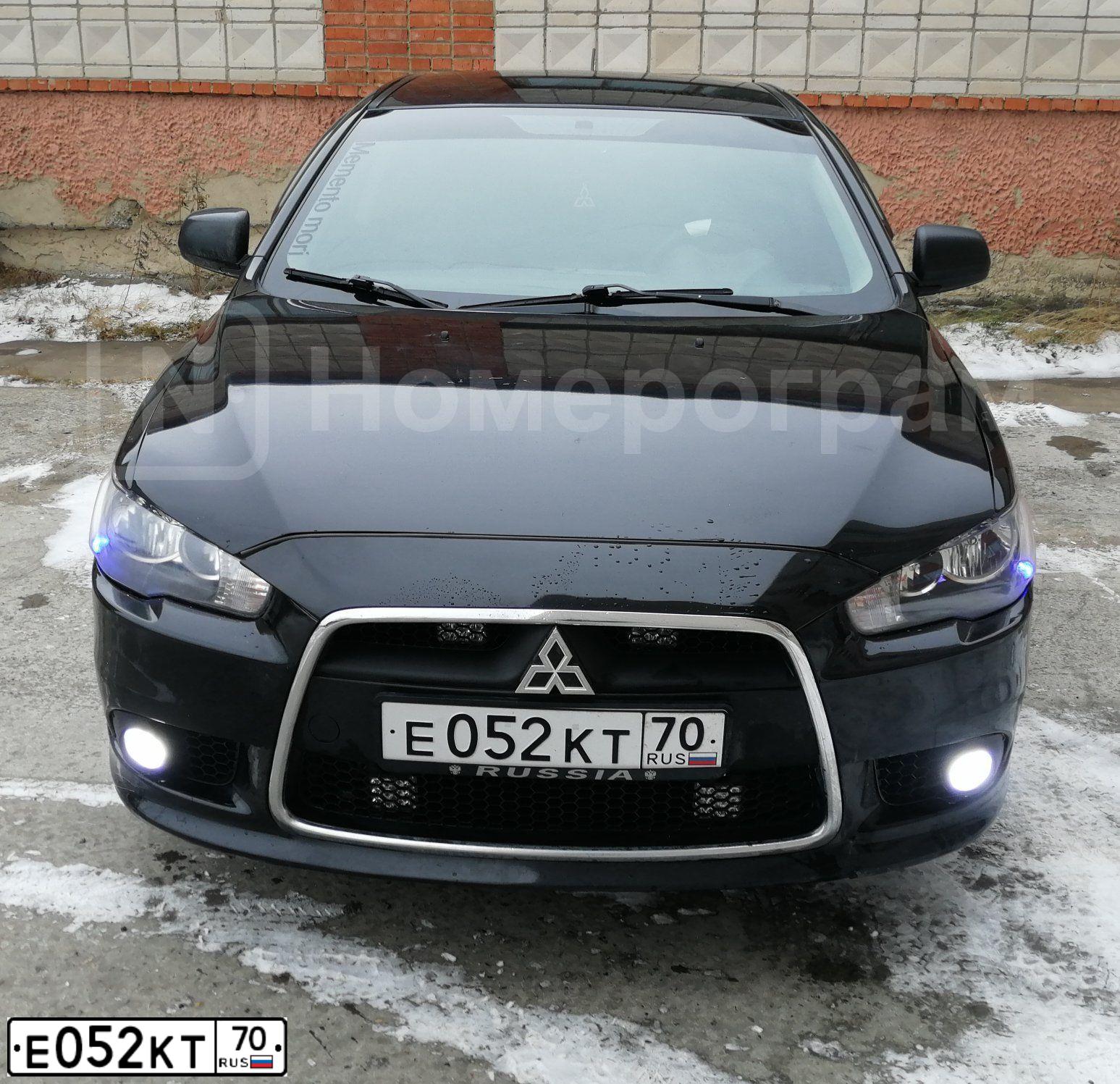 Фото автомобиля MITSUBISHI LANCER, 2012 — госномер Е052КТ70. Цвет: ЧЕРНЫЙ