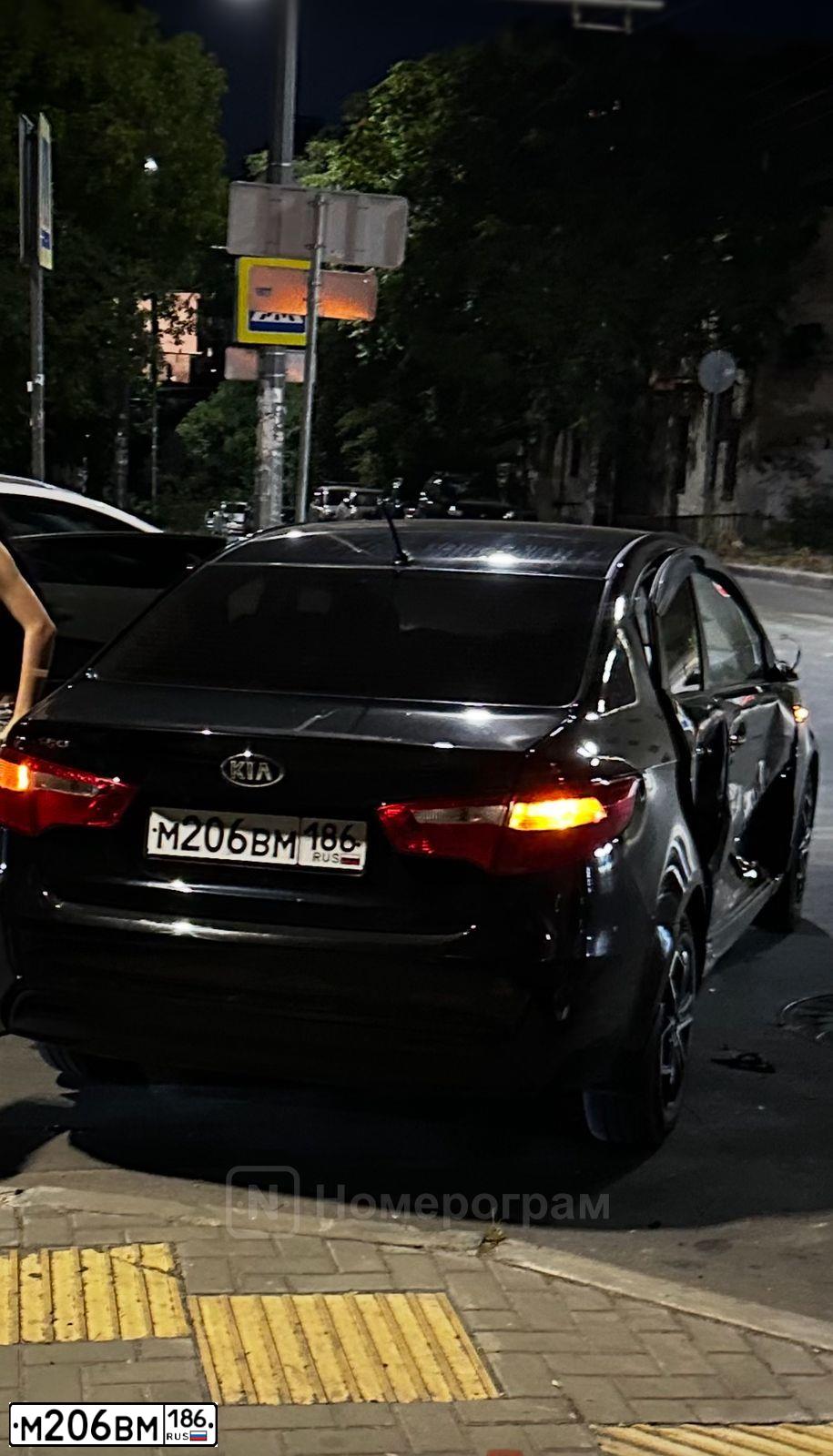 Фото автомобиля KIA RIO, 2014 — госномер М206ВМ186. Цвет: ЧЕРНЫЙ