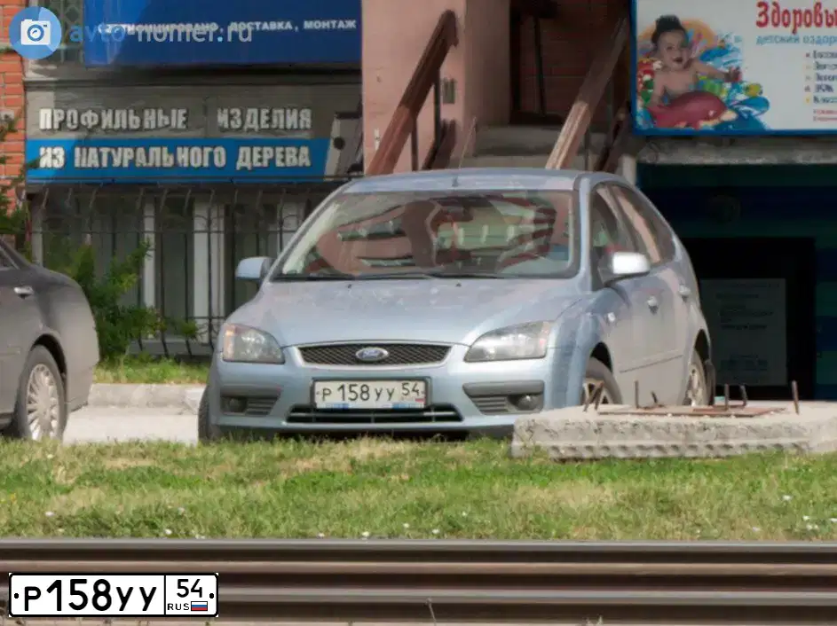 Фото автомобиля FORD FOCUS, 2007 — госномер Р158УУ54. Цвет: СВЕТЛО СЕРО ГОЛУБОЙ